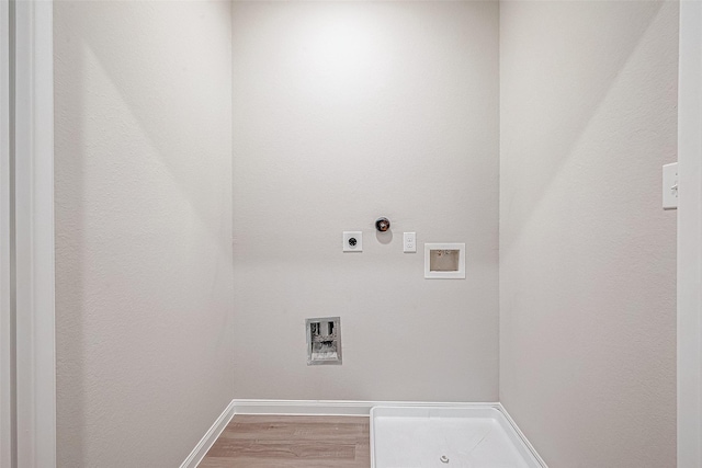 clothes washing area with hardwood / wood-style floors, electric dryer hookup, and washer hookup