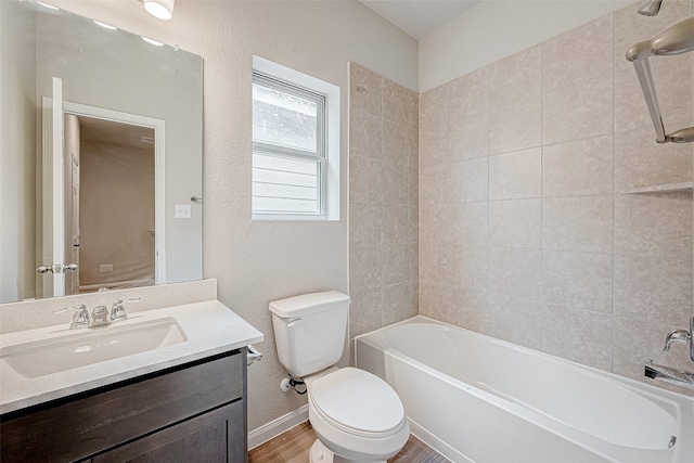 full bathroom featuring toilet, vanity, hardwood / wood-style flooring, and tiled shower / bath