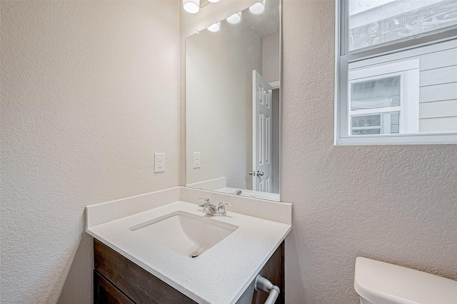 bathroom with toilet and vanity