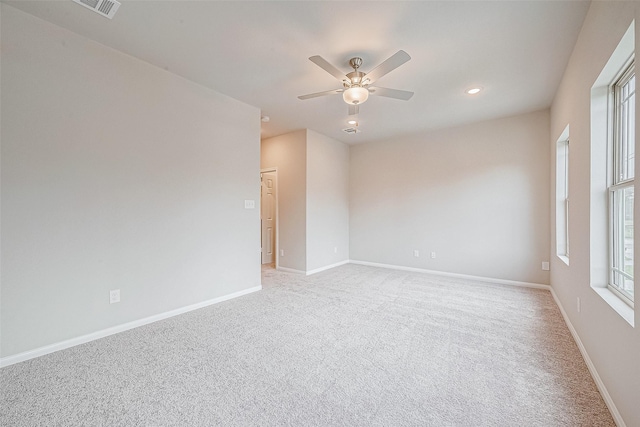 empty room featuring light carpet and ceiling fan