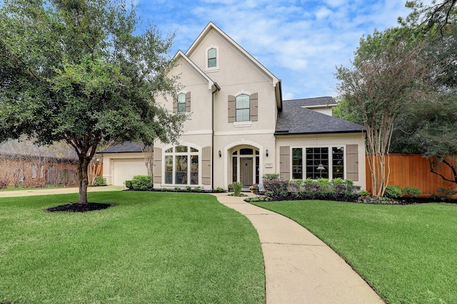 view of front of home featuring a front yard and a garage