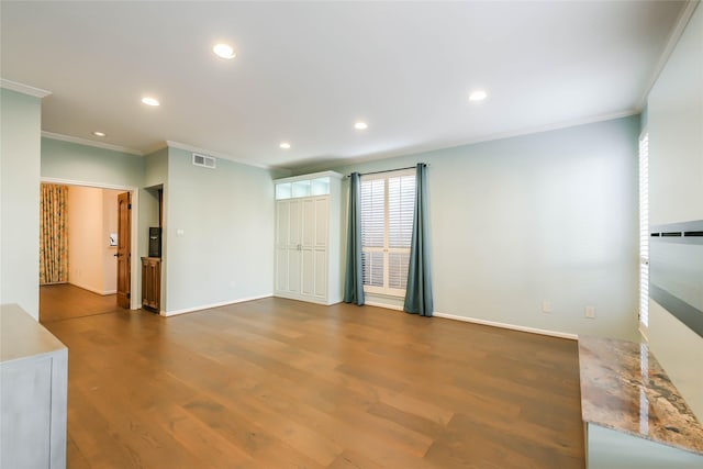 empty room featuring dark hardwood / wood-style floors and ornamental molding