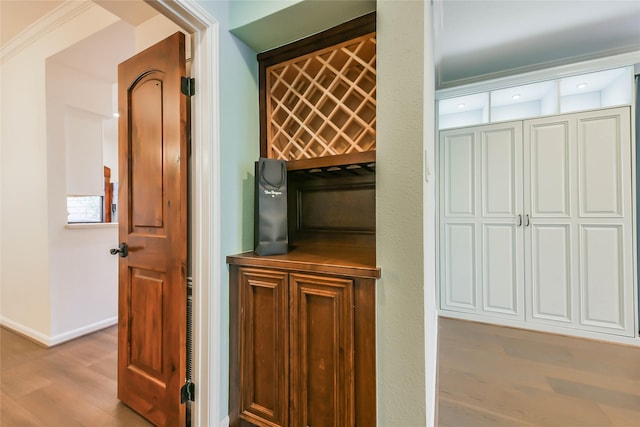 details with hardwood / wood-style flooring and ornamental molding