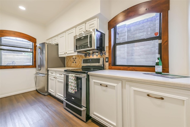 kitchen featuring white cabinets, dark hardwood / wood-style flooring, stainless steel appliances, and tasteful backsplash