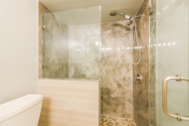 bathroom featuring toilet and an enclosed shower