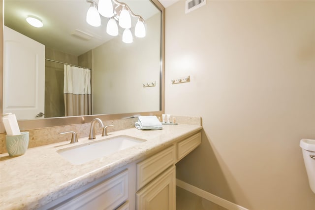 bathroom with vanity, toilet, and walk in shower