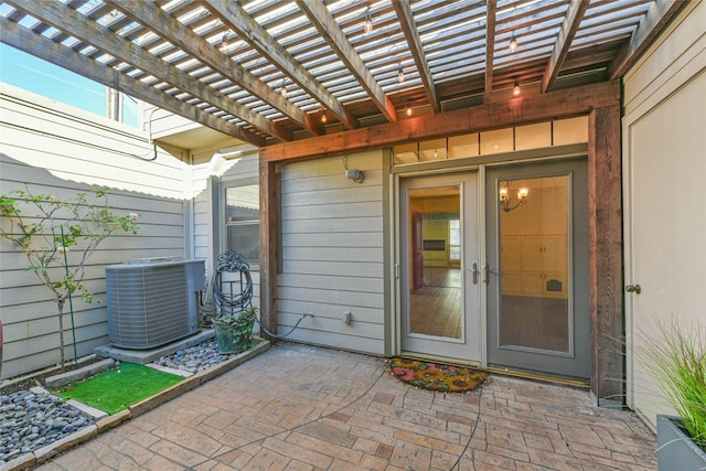 entrance to property with central AC unit, a pergola, and a patio