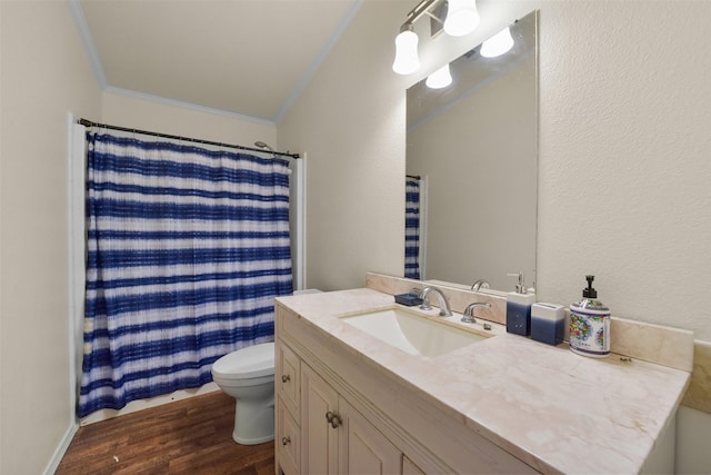 bathroom featuring vanity, crown molding, hardwood / wood-style floors, toilet, and curtained shower