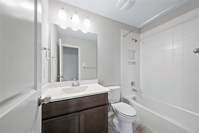 full bathroom featuring toilet, tile patterned flooring, tiled shower / bath, and vanity