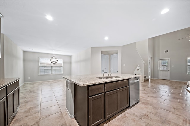 kitchen with dishwasher, a center island with sink, hanging light fixtures, sink, and ceiling fan with notable chandelier