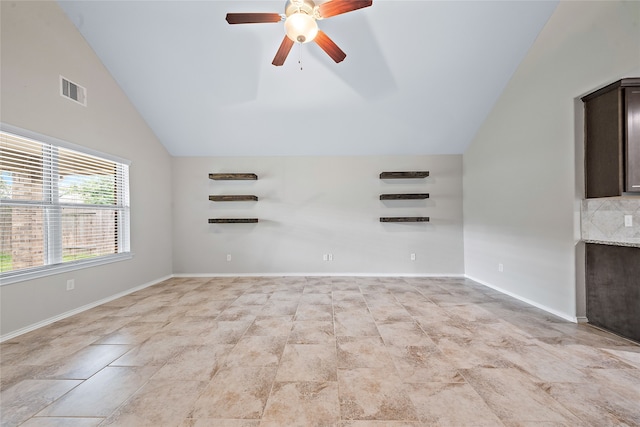 empty room featuring ceiling fan and vaulted ceiling