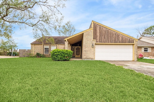 view of front of property with a front lawn and a garage