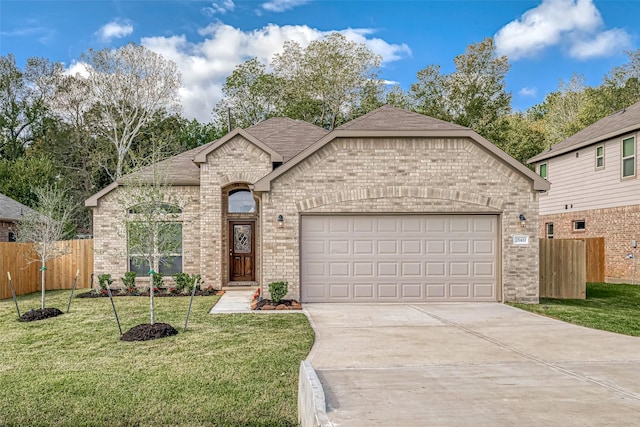 french country inspired facade featuring a front yard and a garage