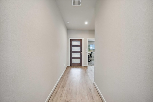 hallway with light hardwood / wood-style flooring