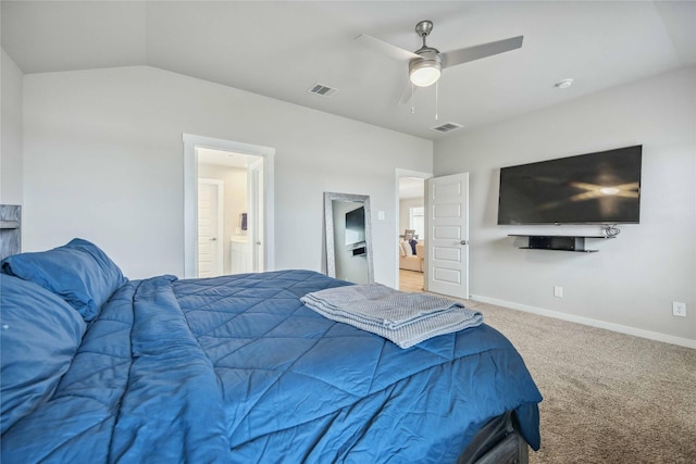 carpeted bedroom with connected bathroom, vaulted ceiling, and ceiling fan