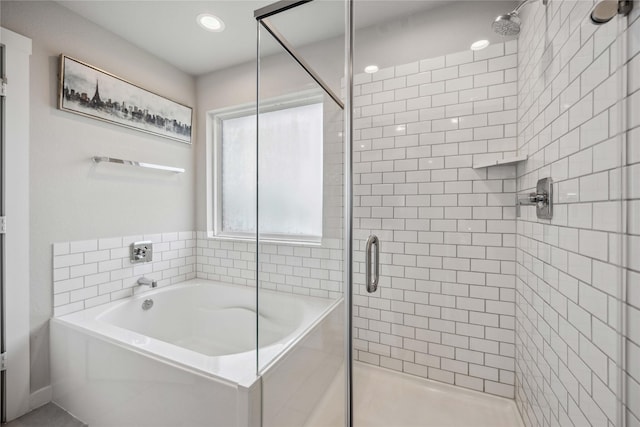 bathroom with shower with separate bathtub