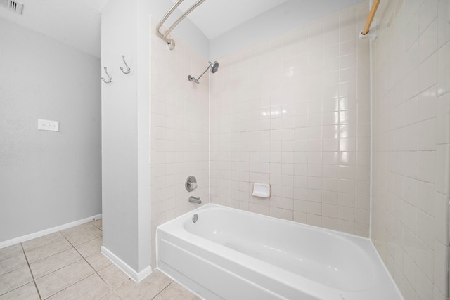 bathroom featuring tile patterned flooring and tiled shower / bath