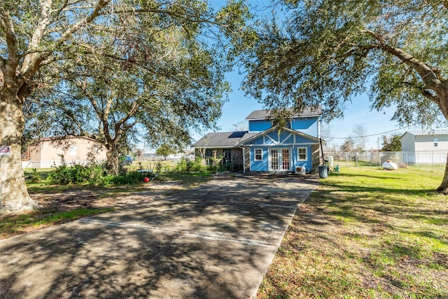 view of front facade with french doors and a front lawn