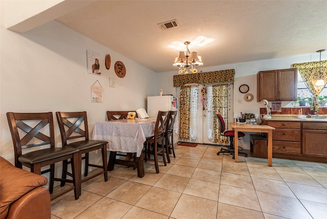 tiled dining area with a notable chandelier and sink