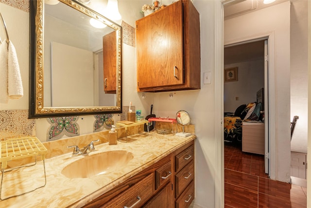 bathroom with tasteful backsplash and vanity