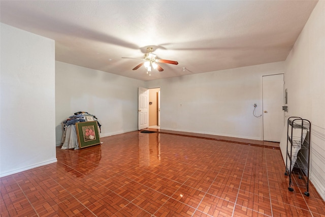 spare room with ceiling fan and parquet floors