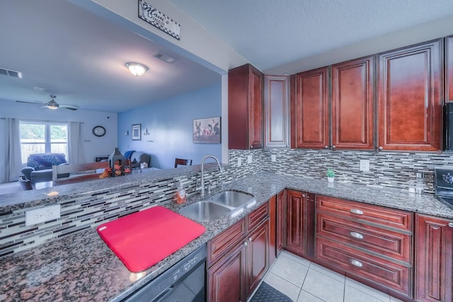 kitchen with backsplash, ceiling fan, sink, and dark stone counters