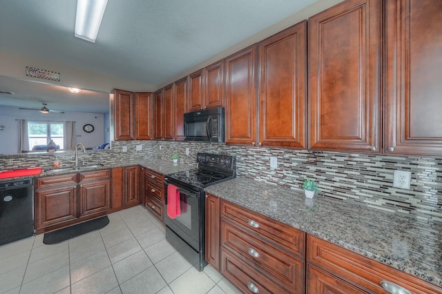 kitchen featuring ceiling fan, sink, stone countertops, decorative backsplash, and black appliances