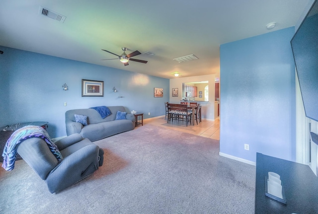 living room with light colored carpet and ceiling fan