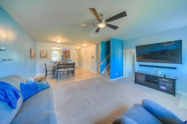 carpeted living room with ceiling fan