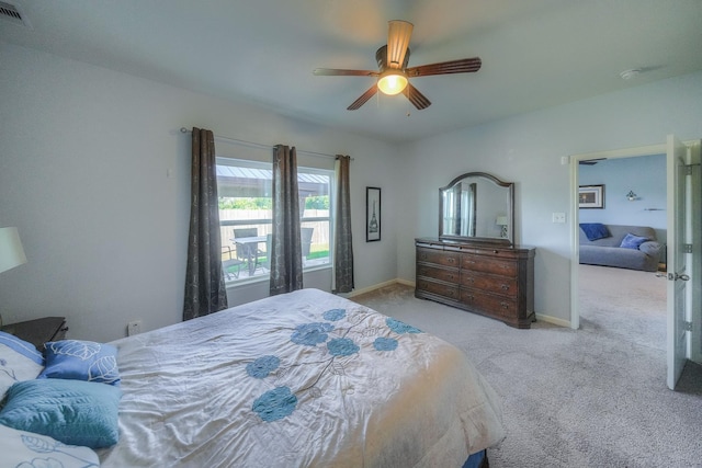 bedroom featuring light colored carpet and ceiling fan