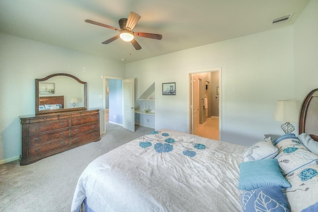 bedroom featuring light carpet, connected bathroom, and ceiling fan