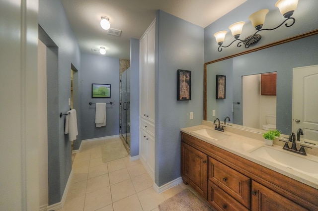 bathroom featuring walk in shower, tile patterned flooring, vanity, and toilet