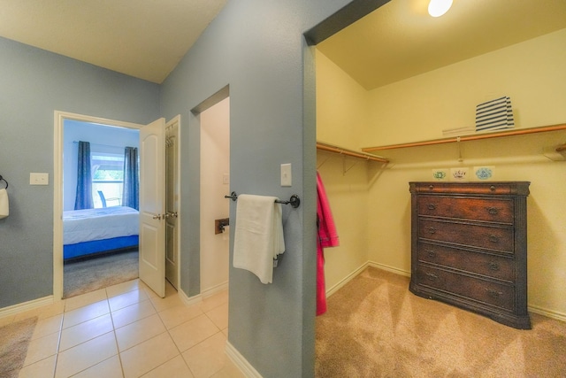 walk in closet with light tile patterned floors