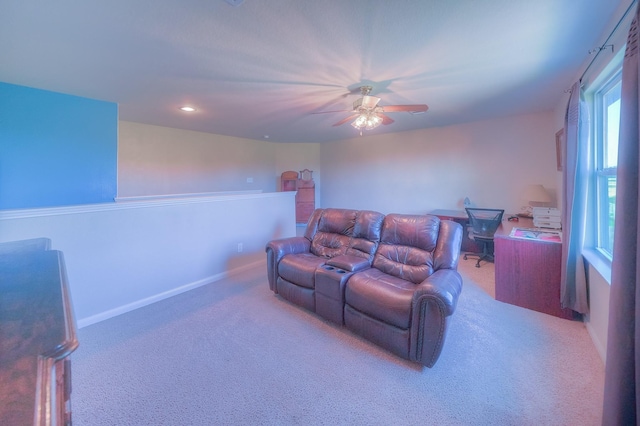 carpeted home theater room featuring ceiling fan and a healthy amount of sunlight