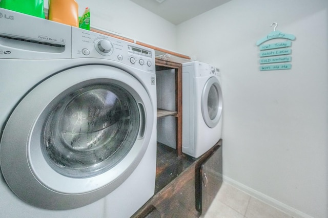 clothes washing area featuring independent washer and dryer