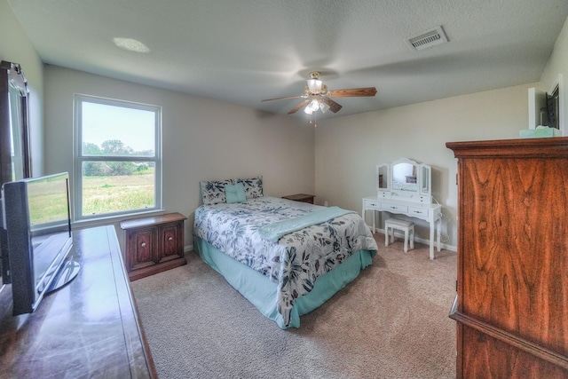 bedroom featuring ceiling fan and carpet