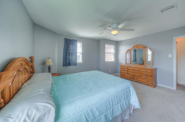 bedroom with ceiling fan and light carpet