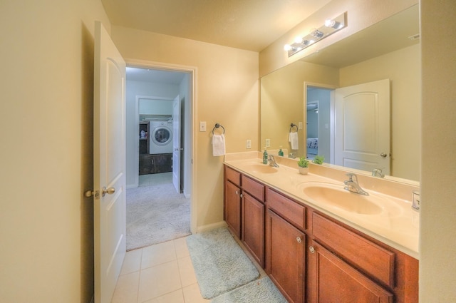 bathroom featuring tile patterned flooring, washer / dryer, and vanity