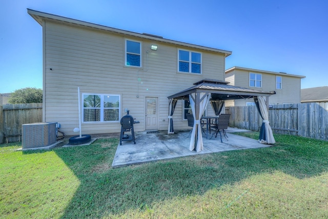 rear view of property with a gazebo, central AC, a patio area, and a yard