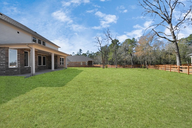 view of yard featuring a patio area and a fenced backyard