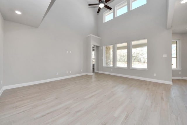 unfurnished living room with a ceiling fan, recessed lighting, light wood-style flooring, and baseboards