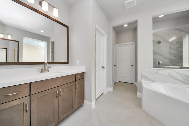 full bathroom featuring vanity, visible vents, baseboards, a bath, and a shower with door