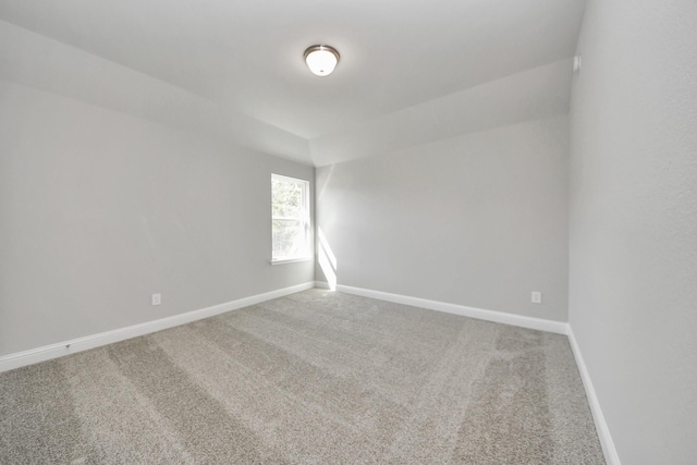 carpeted spare room with baseboards