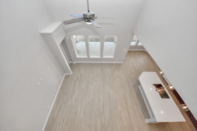 bonus room featuring ceiling fan, light wood-type flooring, lofted ceiling, and baseboards