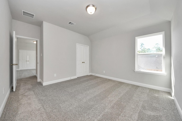 unfurnished bedroom featuring carpet floors, visible vents, and baseboards