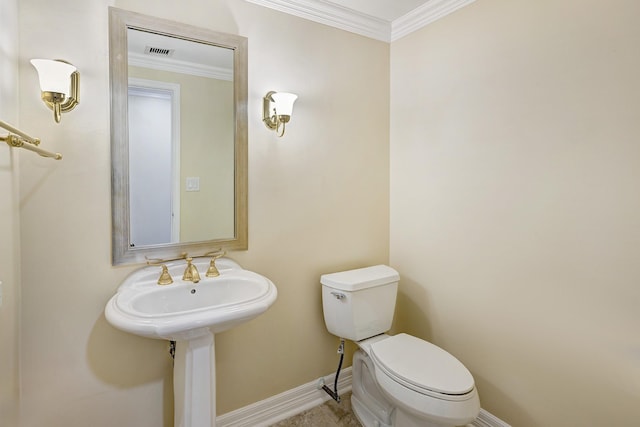 bathroom with toilet and crown molding