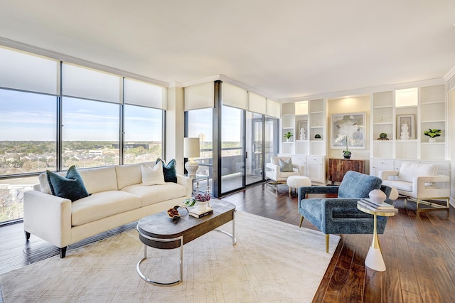 living room featuring hardwood / wood-style floors, expansive windows, and built in features