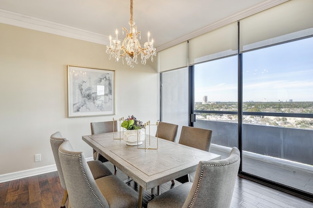 dining space with floor to ceiling windows, wood-type flooring, ornamental molding, and a chandelier