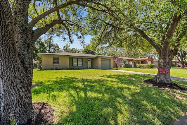 ranch-style home with a front yard and a garage