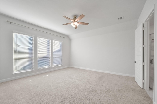 carpeted empty room featuring lofted ceiling and ceiling fan